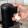 Hot Lather Machine Dispensing Hot Lather in Shower Caddy